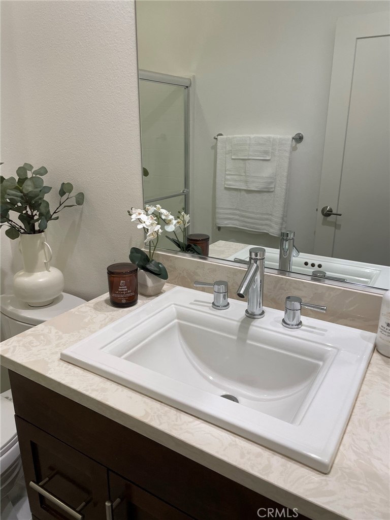37 Soho Irvine, CA 92612 - Photo 8 of 11 a bathroom with a sink and a mirror