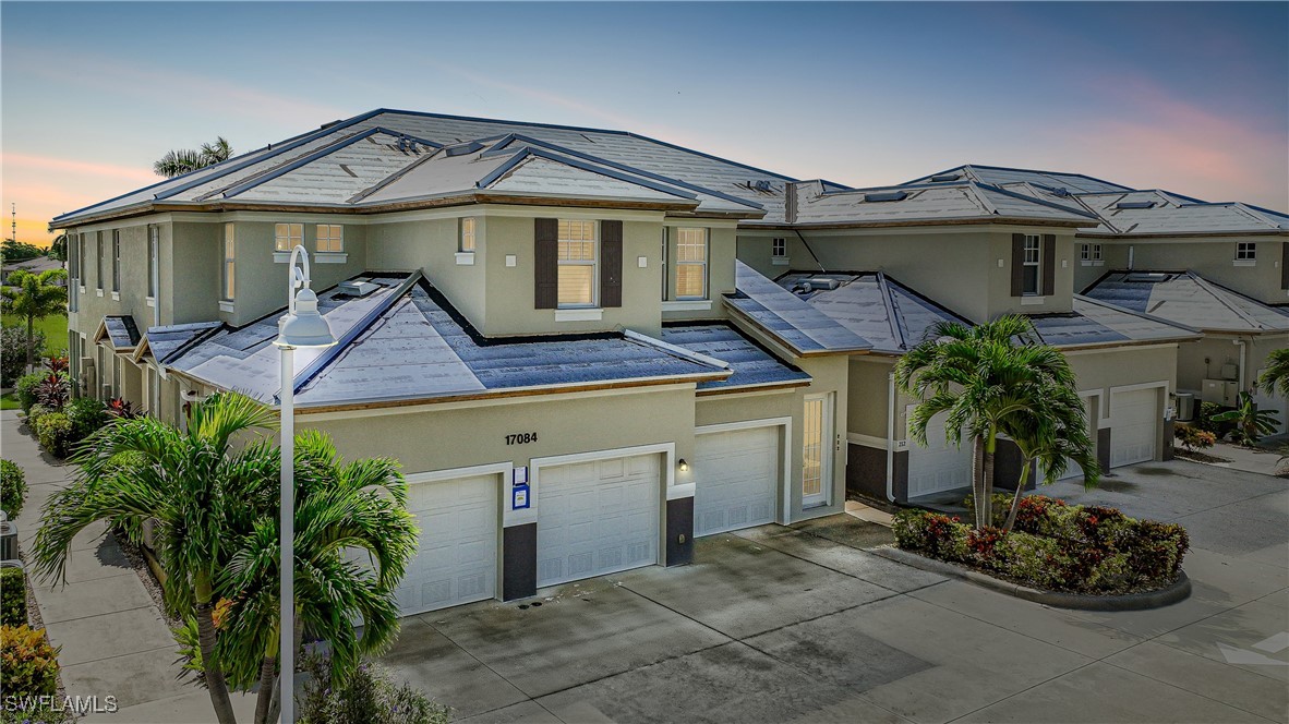 17084 Acapulco Road, Unit 211 Punta Gorda, FL 33955 - Photo 1 of 45 a front view of a house with a garden and entryway