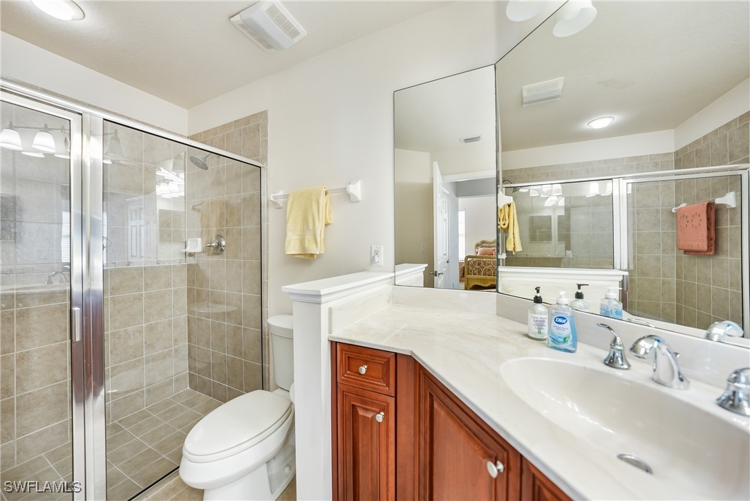 17084 Acapulco Road, Unit 211 Punta Gorda, FL 33955 - Photo 11 of 45 a bathroom with a sink a toilet and shower
