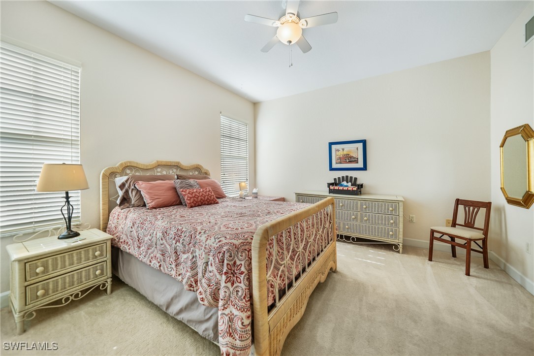 17084 Acapulco Road, Unit 211 Punta Gorda, FL 33955 - Photo 13 of 45 a bedroom with a bed and a chandelier