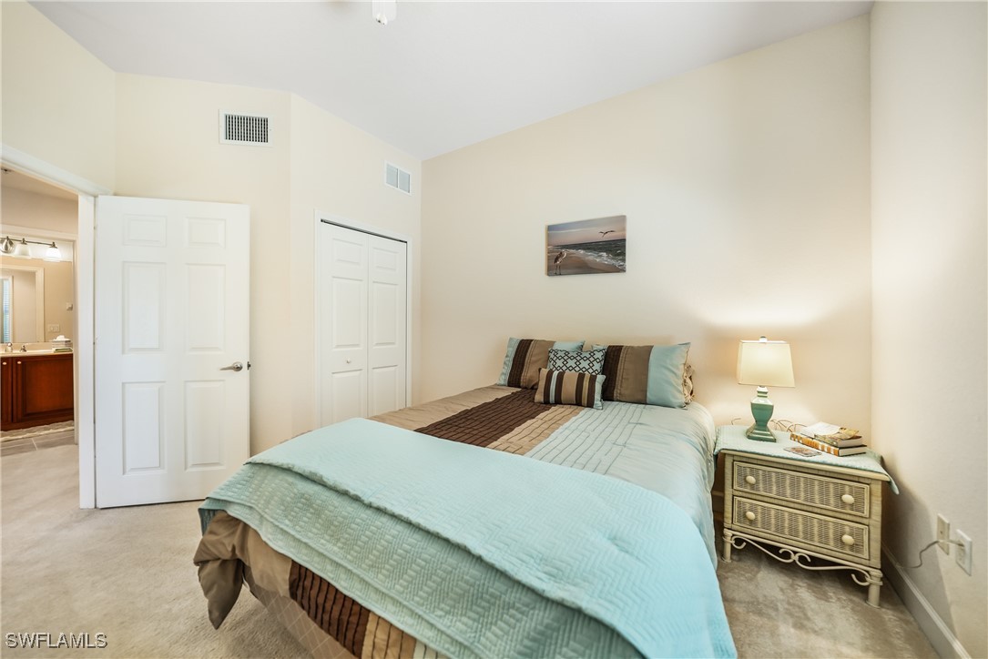 17084 Acapulco Road, Unit 211 Punta Gorda, FL 33955 - Photo 16 of 45 a bedroom with a bed and a cabinets