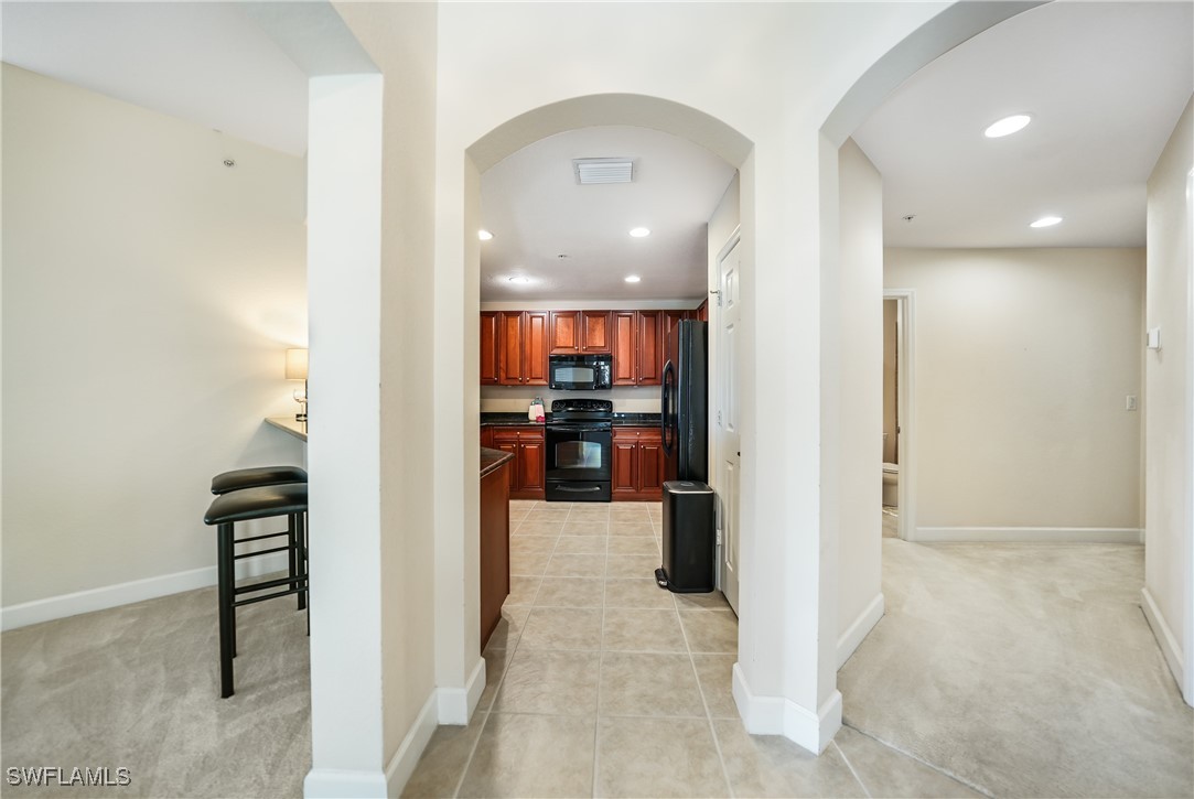 17084 Acapulco Road, Unit 211 Punta Gorda, FL 33955 - Photo 18 of 45 a view of a hallway with a living room