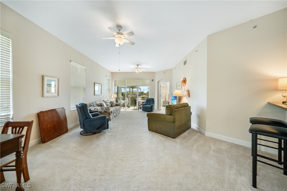 17084 Acapulco Road, Unit 211 Punta Gorda, FL 33955 - Photo 19 of 45 a living room with furniture and a chandelier