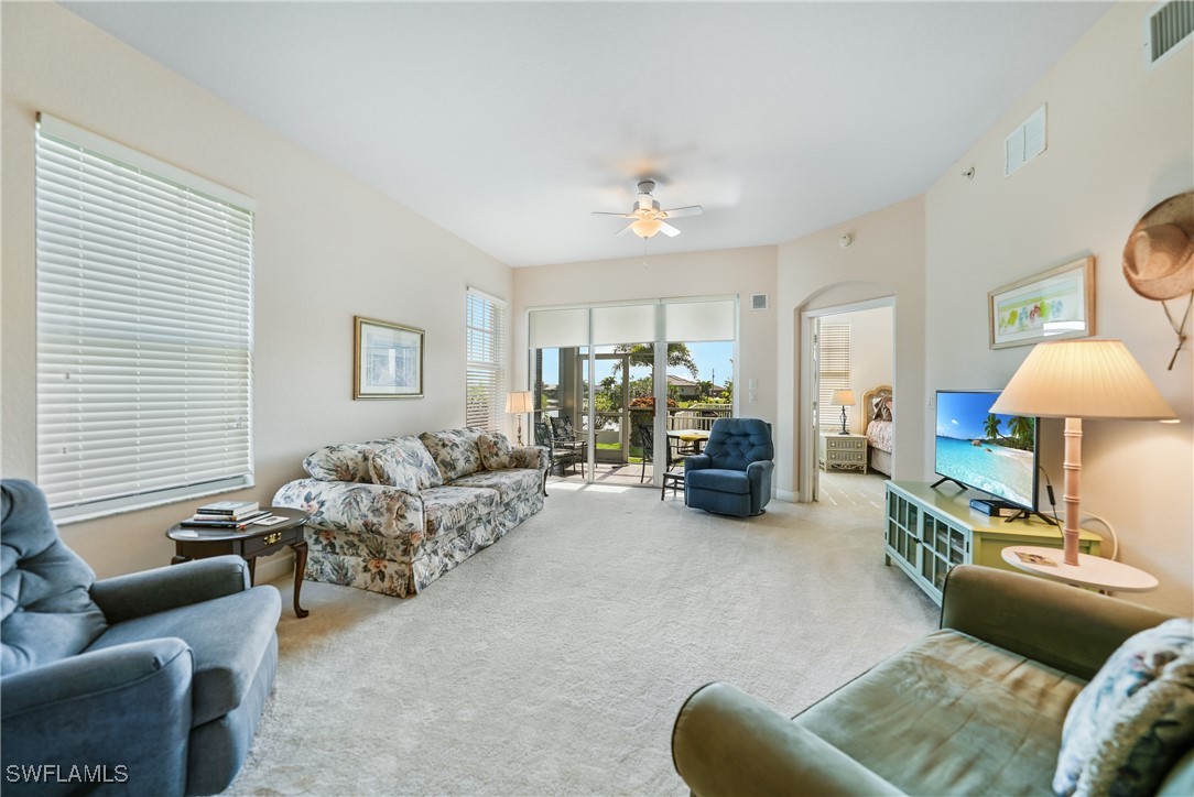 17084 Acapulco Road, Unit 211 Punta Gorda, FL 33955 - Photo 20 of 45 a living room with furniture a lamp and a window