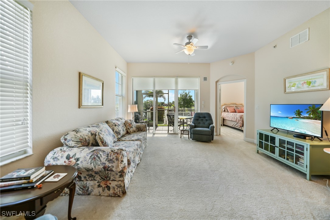 17084 Acapulco Road, Unit 211 Punta Gorda, FL 33955 - Photo 21 of 45 a living room with furniture and a flat screen tv