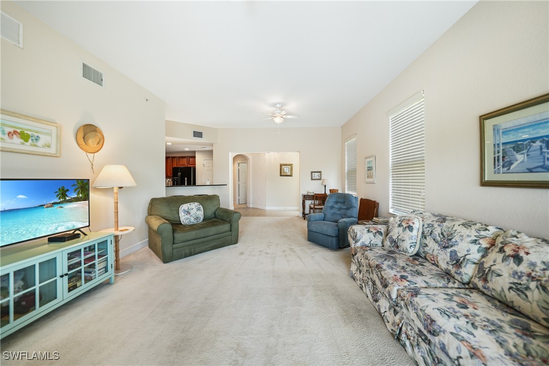 17084 Acapulco Road, Unit 211 Punta Gorda, FL 33955 - Photo 23 of 45 a living room with furniture and a flat screen tv