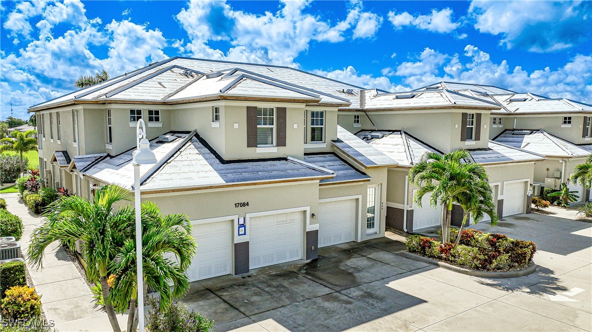 17084 Acapulco Road, Unit 211 Punta Gorda, FL 33955 - Photo 31 of 45 a front view of a house with garden