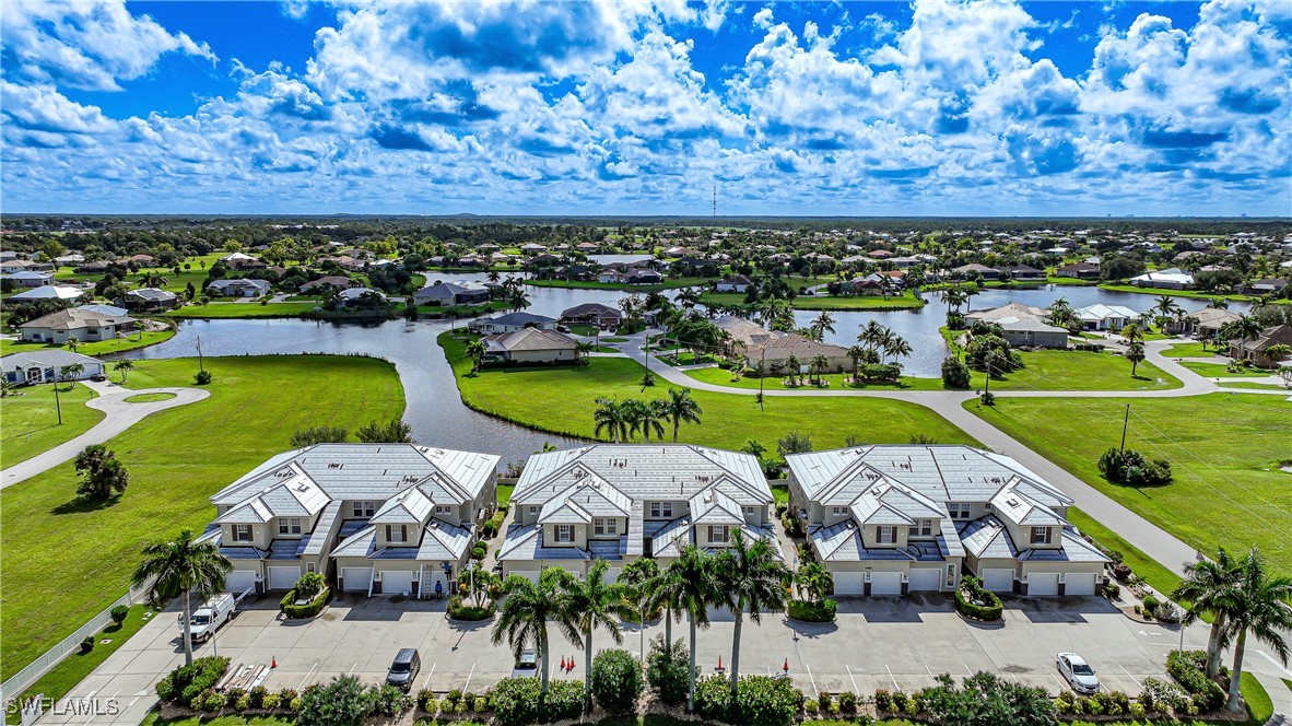 17084 Acapulco Road, Unit 211 Punta Gorda, FL 33955 - Photo 33 of 45 an aerial view of a house with a garden and lake view