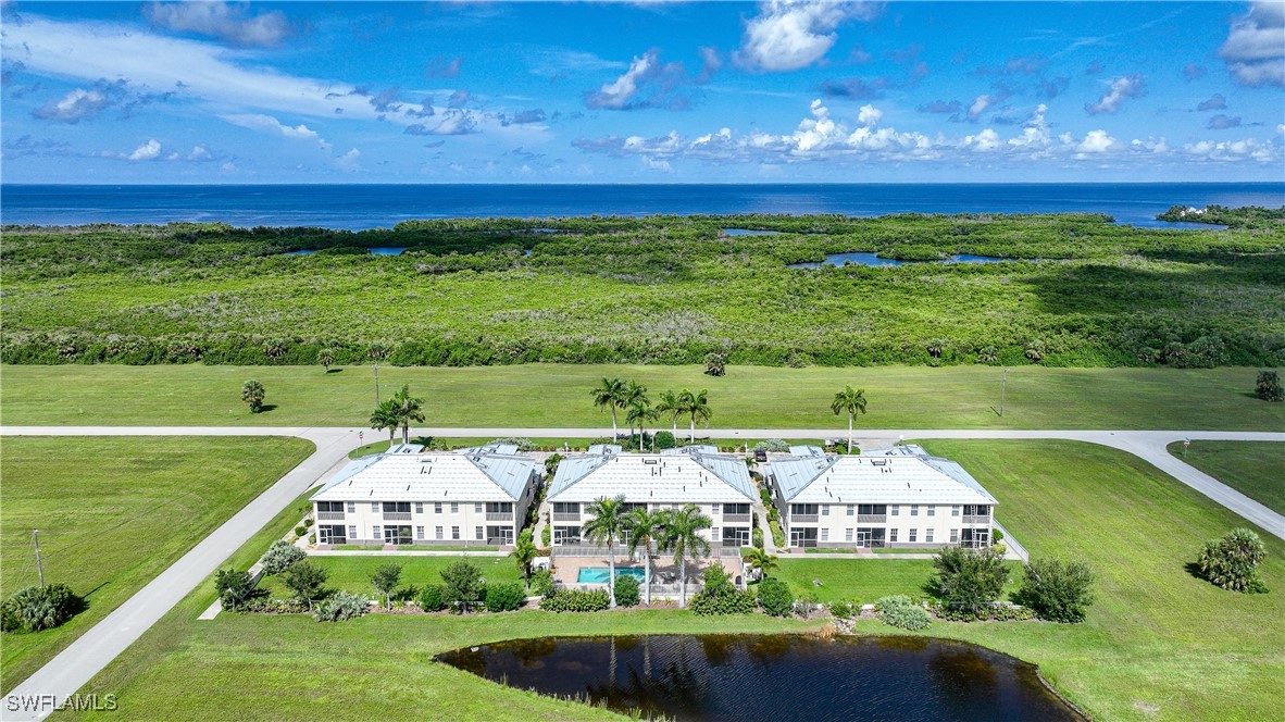 17084 Acapulco Road, Unit 211 Punta Gorda, FL 33955 - Photo 35 of 45 a view of a golf course with a building