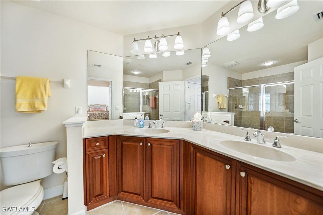 17084 Acapulco Road, Unit 211 Punta Gorda, FL 33955 - Photo 9 of 45 a spacious bathroom with a sink a toilet a mirror and vanity