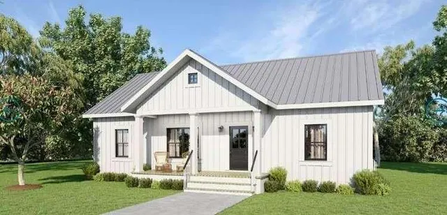 a view of a house with a yard and potted plants