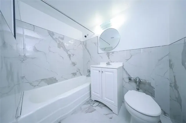 a bathroom with a sink a toilet and bathtub