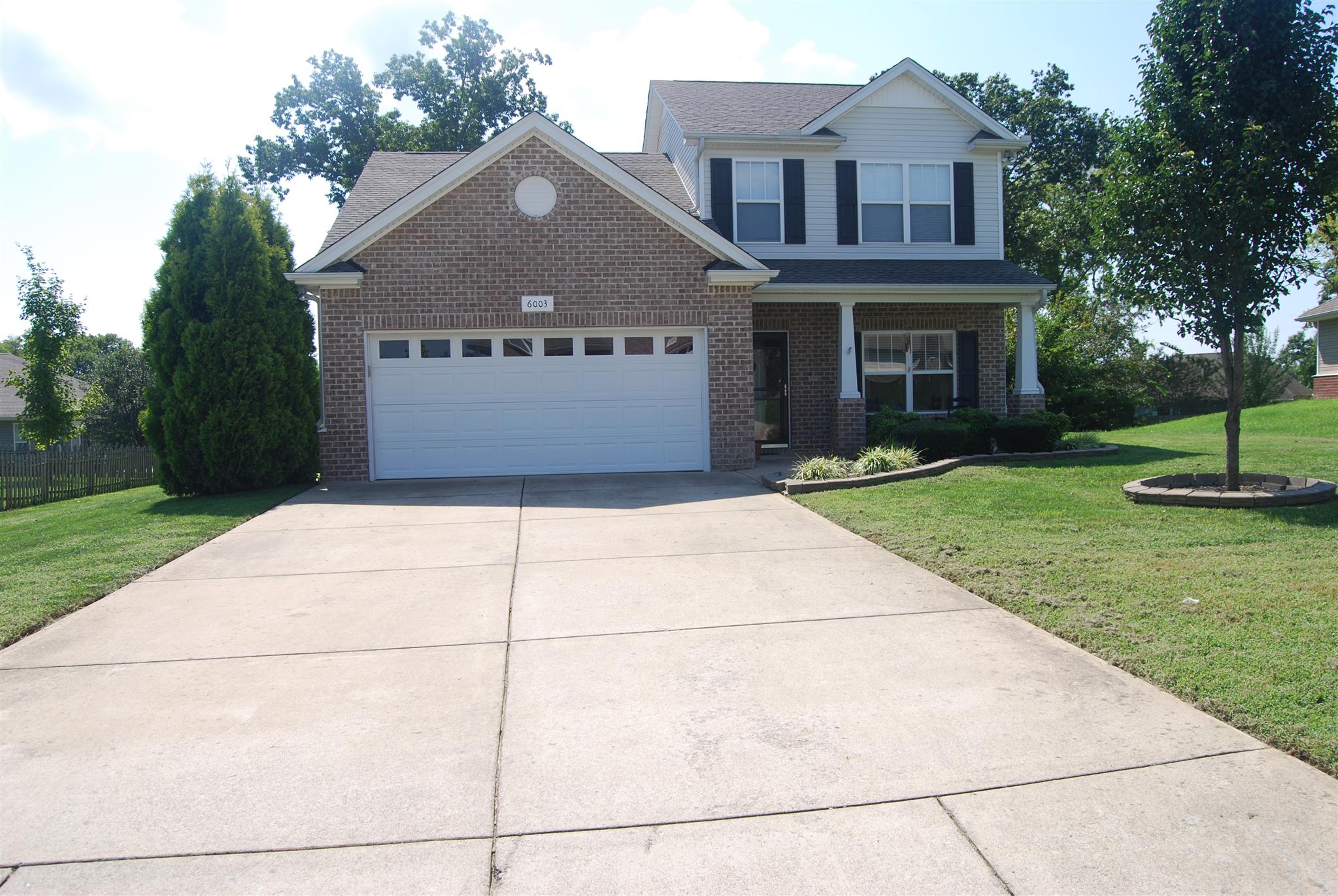 6003 Chickadee Circle Spring Hill, TN 37174 - Photo 2 of 23 a front view of a house with a garden