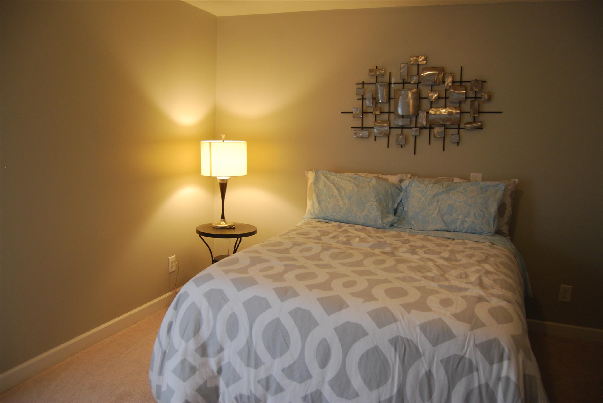 6003 Chickadee Circle Spring Hill, TN 37174 - Photo 15 of 23 a bed sitting in a bedroom next to a lamp