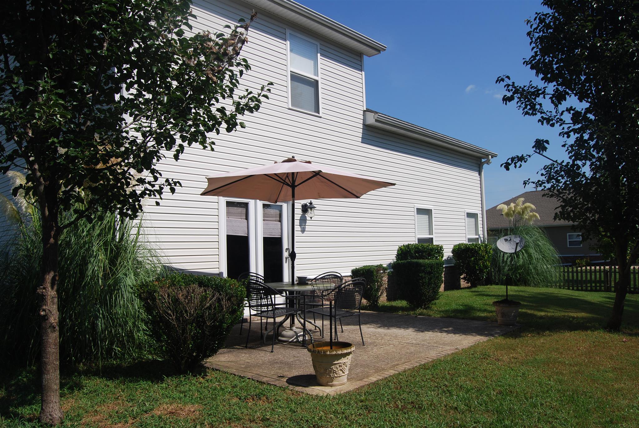 6003 Chickadee Circle Spring Hill, TN 37174 - Photo 20 of 23 a view of a chair and table in backyard of the house