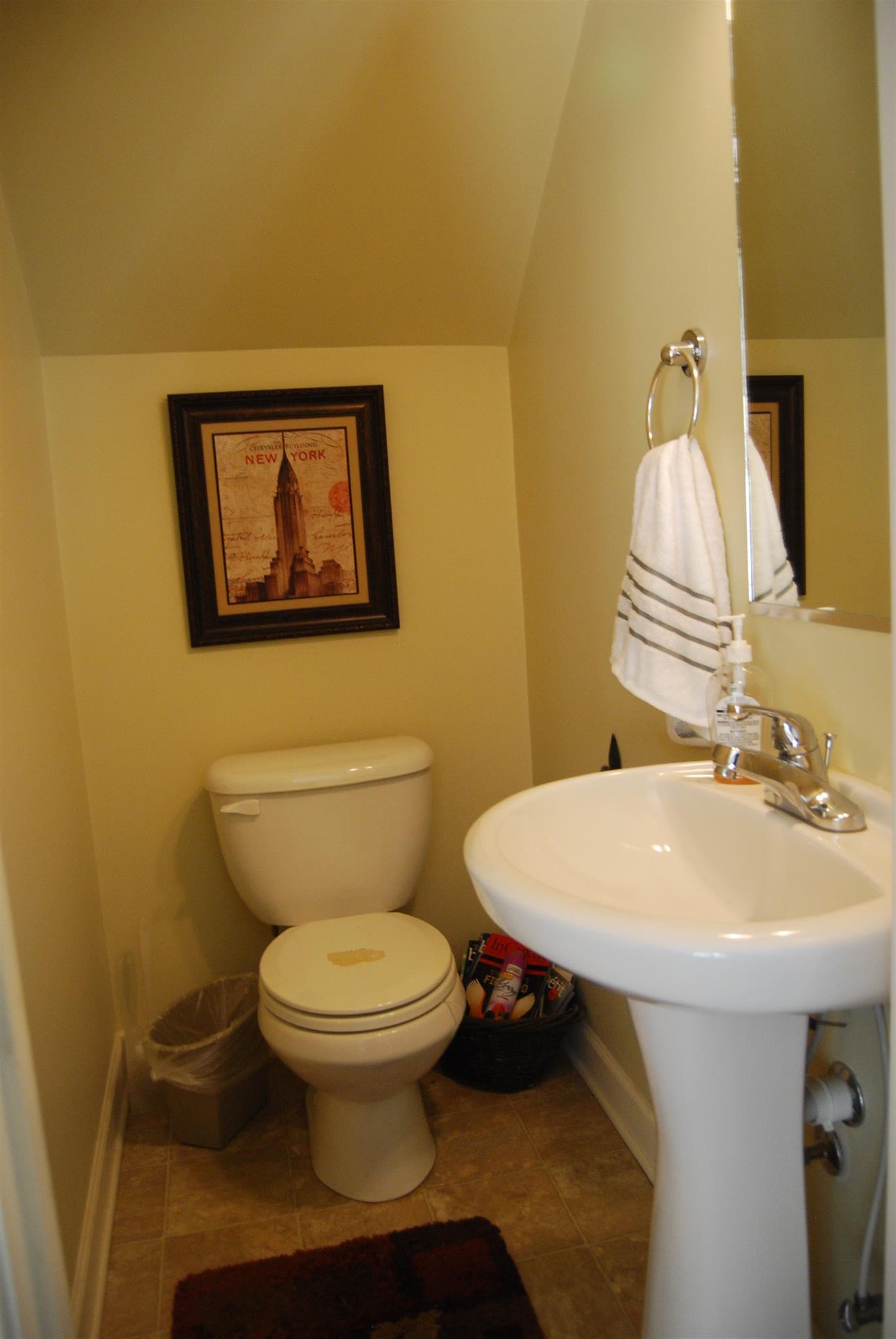 6003 Chickadee Circle Spring Hill, TN 37174 - Photo 6 of 23 a bathroom with a toilet sink and mirror