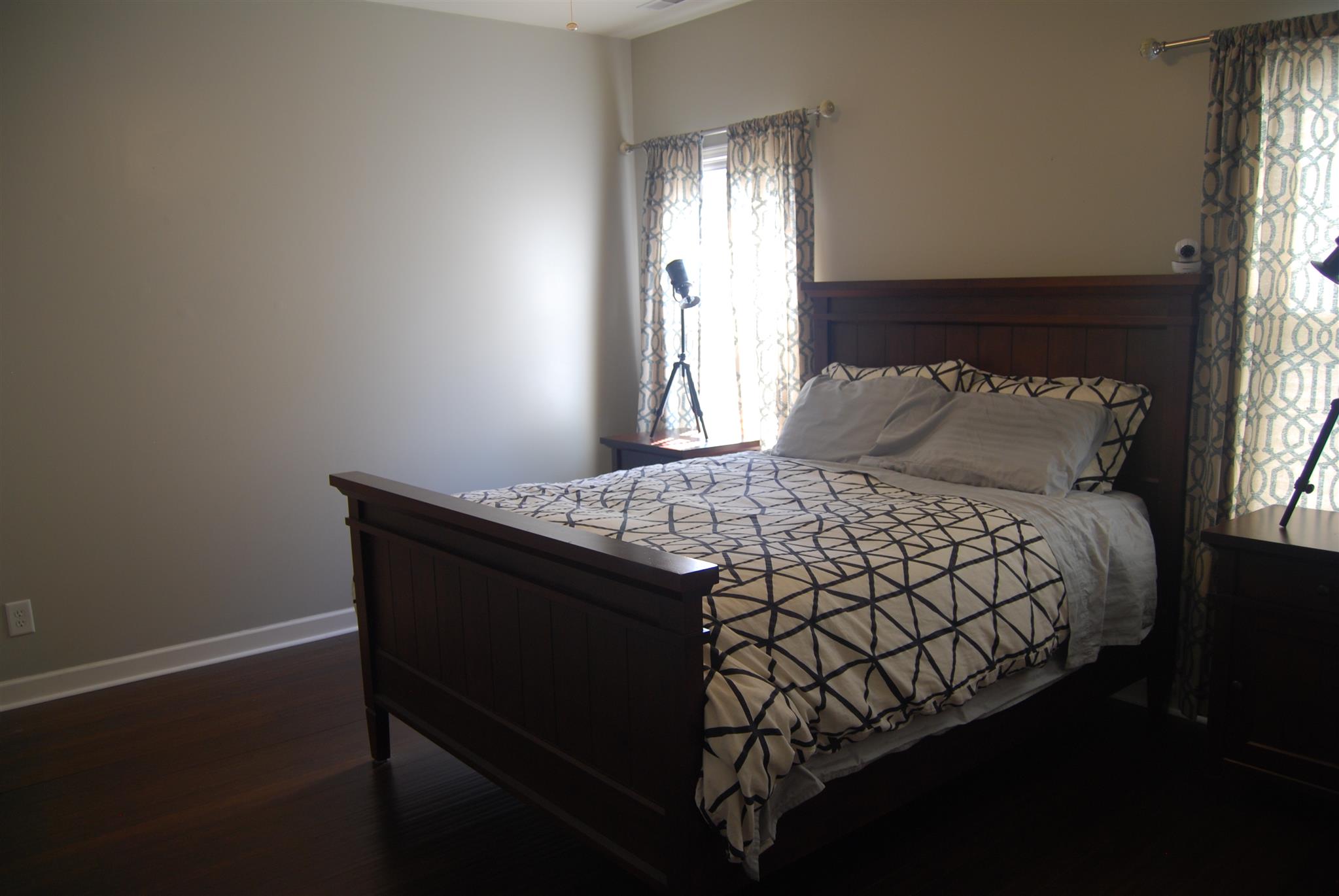 6003 Chickadee Circle Spring Hill, TN 37174 - Photo 10 of 23 a bed sitting in a bedroom next to a window and chandelier