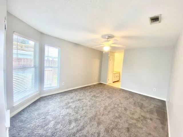 a view of an empty room with a window