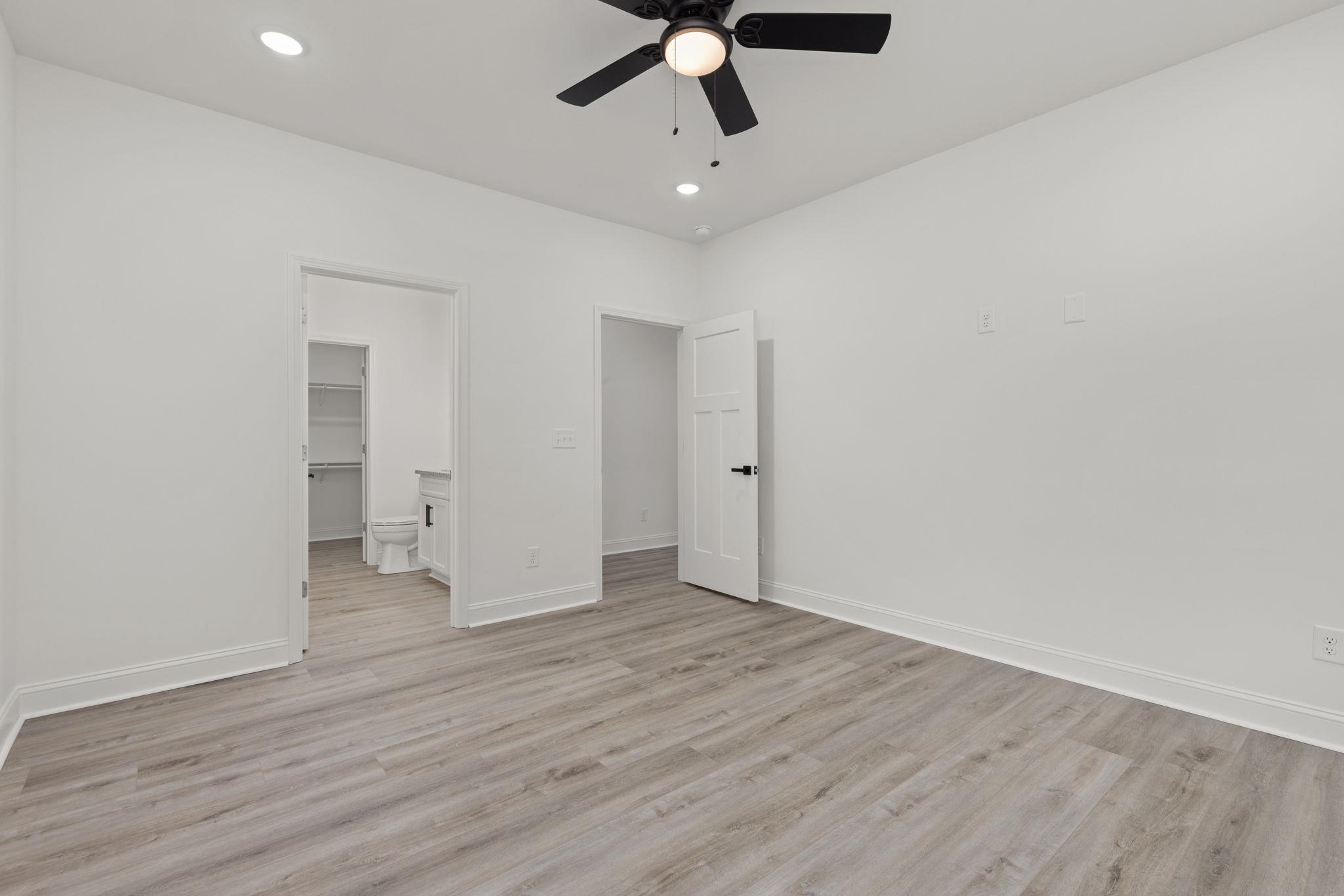 458 County Road 514 Rienzi, MS 38865 - Photo 9 of 34 wooden floor in an empty room with a ceiling fan