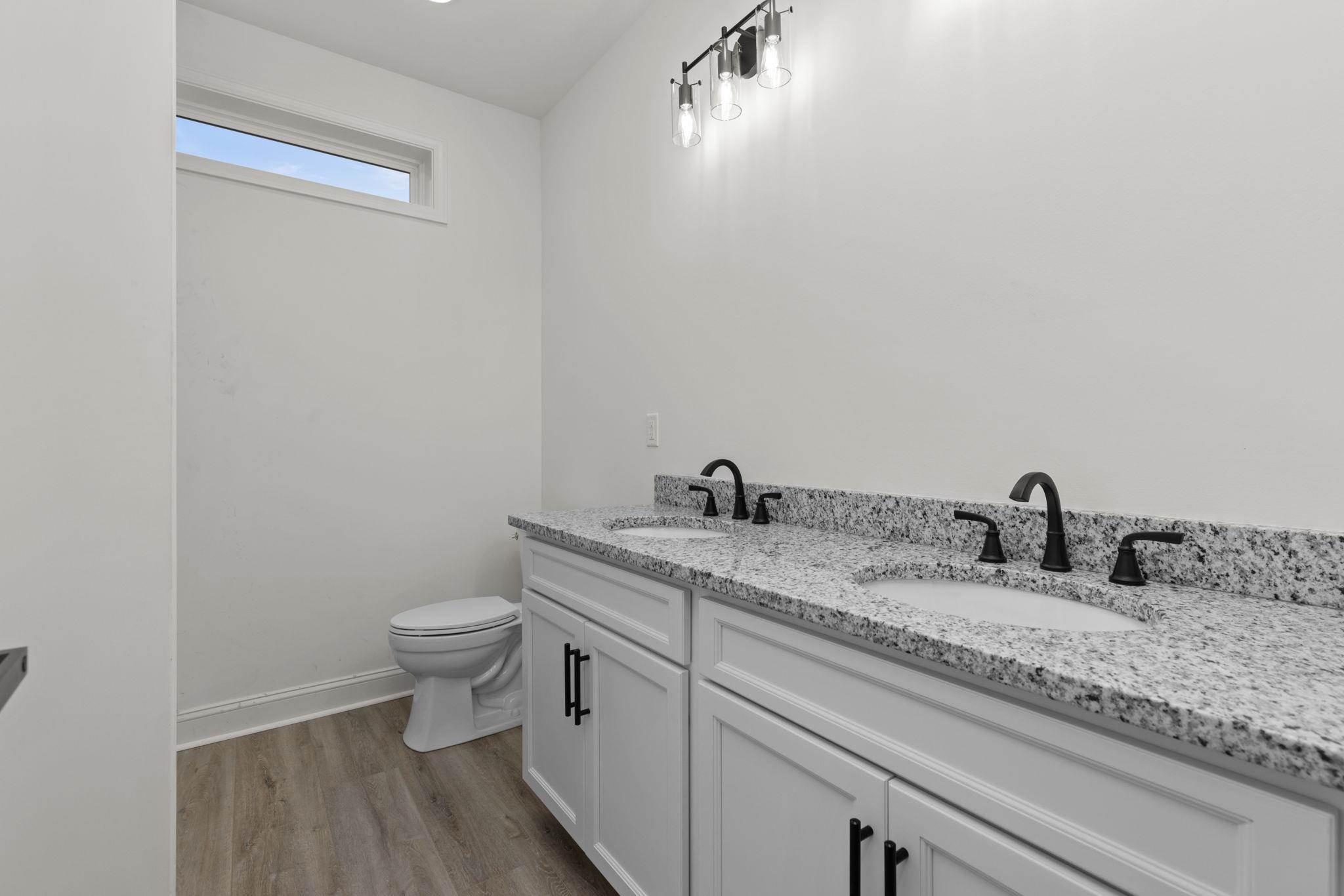 458 County Road 514 Rienzi, MS 38865 - Photo 16 of 34 a bathroom with a granite countertop toilet and sink
