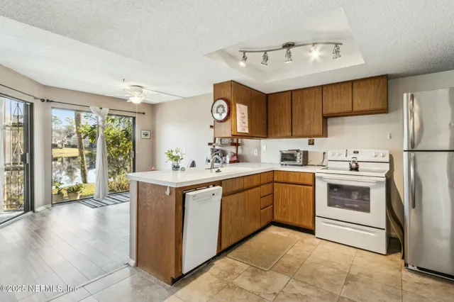 a view of a kitchen with a sink and cabinets