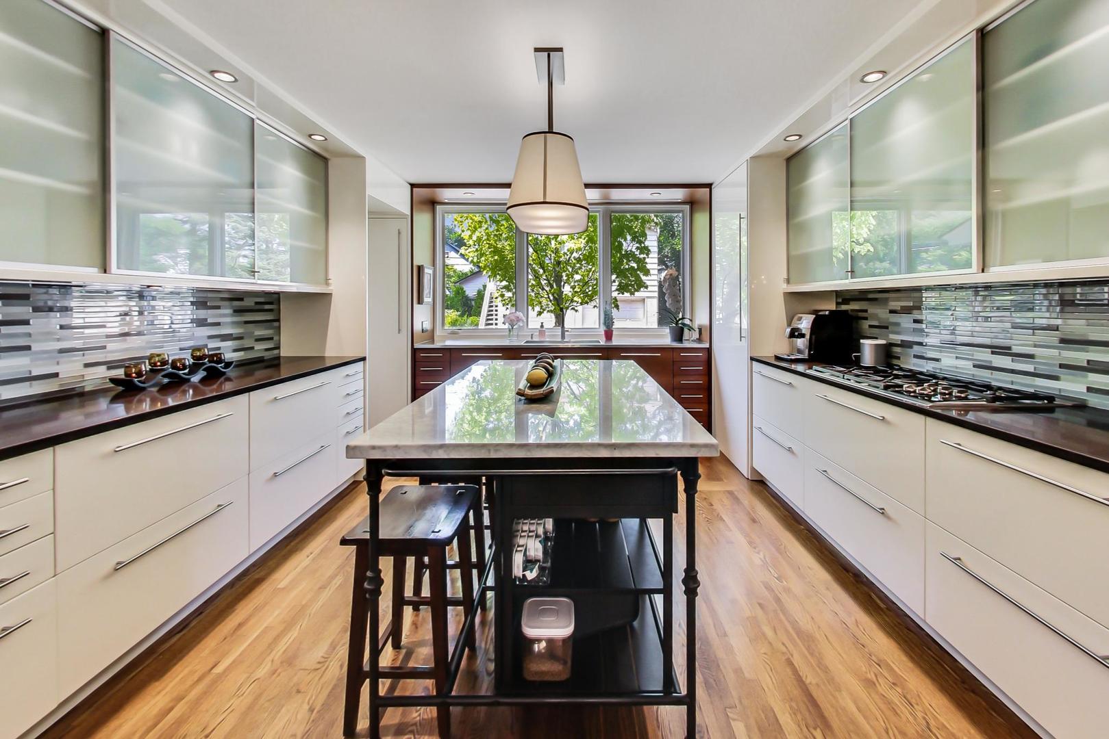 385 Washington Avenue Glencoe, IL 60022 - Photo 15 of 50 a kitchen with a stove and white cabinets