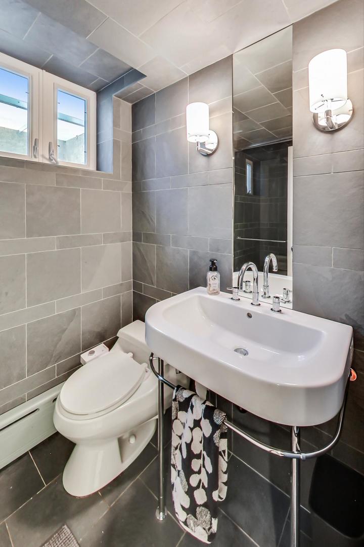 385 Washington Avenue Glencoe, IL 60022 - Photo 36 of 50 a bathroom with a sink a toilet and a mirror