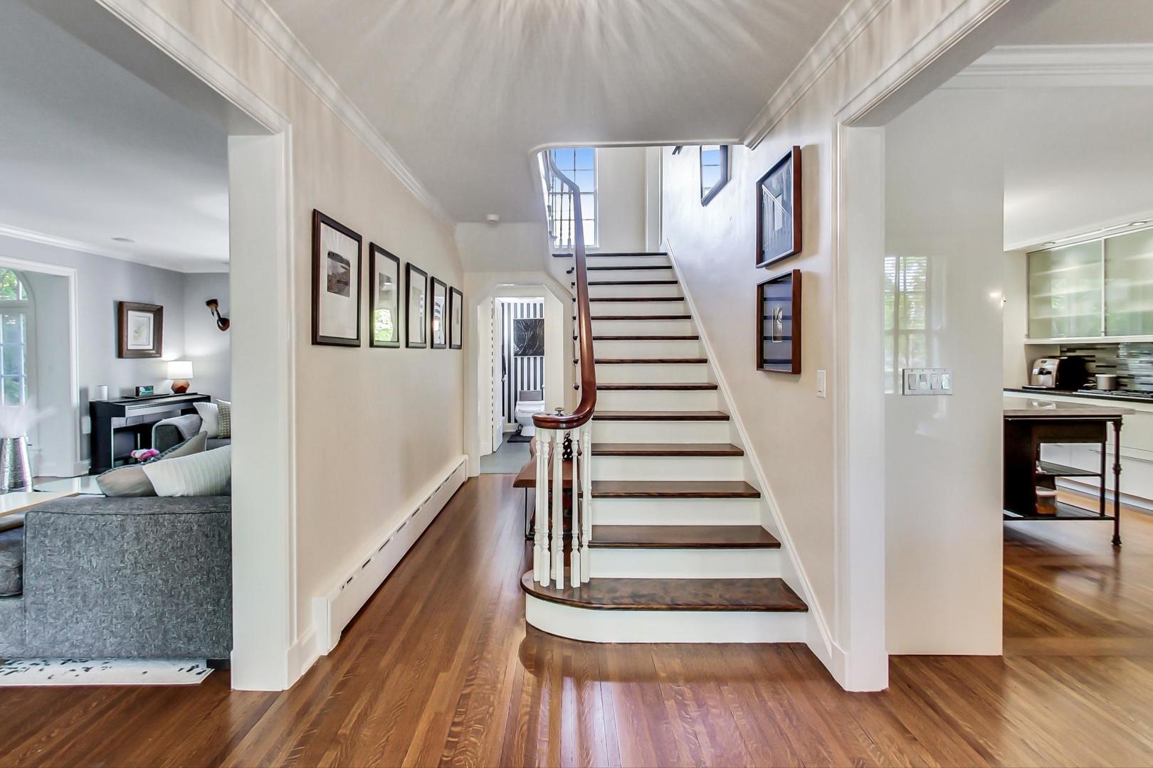 385 Washington Avenue Glencoe, IL 60022 - Photo 4 of 50 a view of a livingroom with wooden floor and stairs