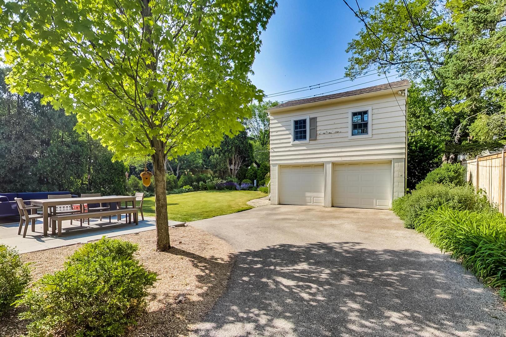 385 Washington Avenue Glencoe, IL 60022 - Photo 41 of 50 a front view of a house with garden and sitting area