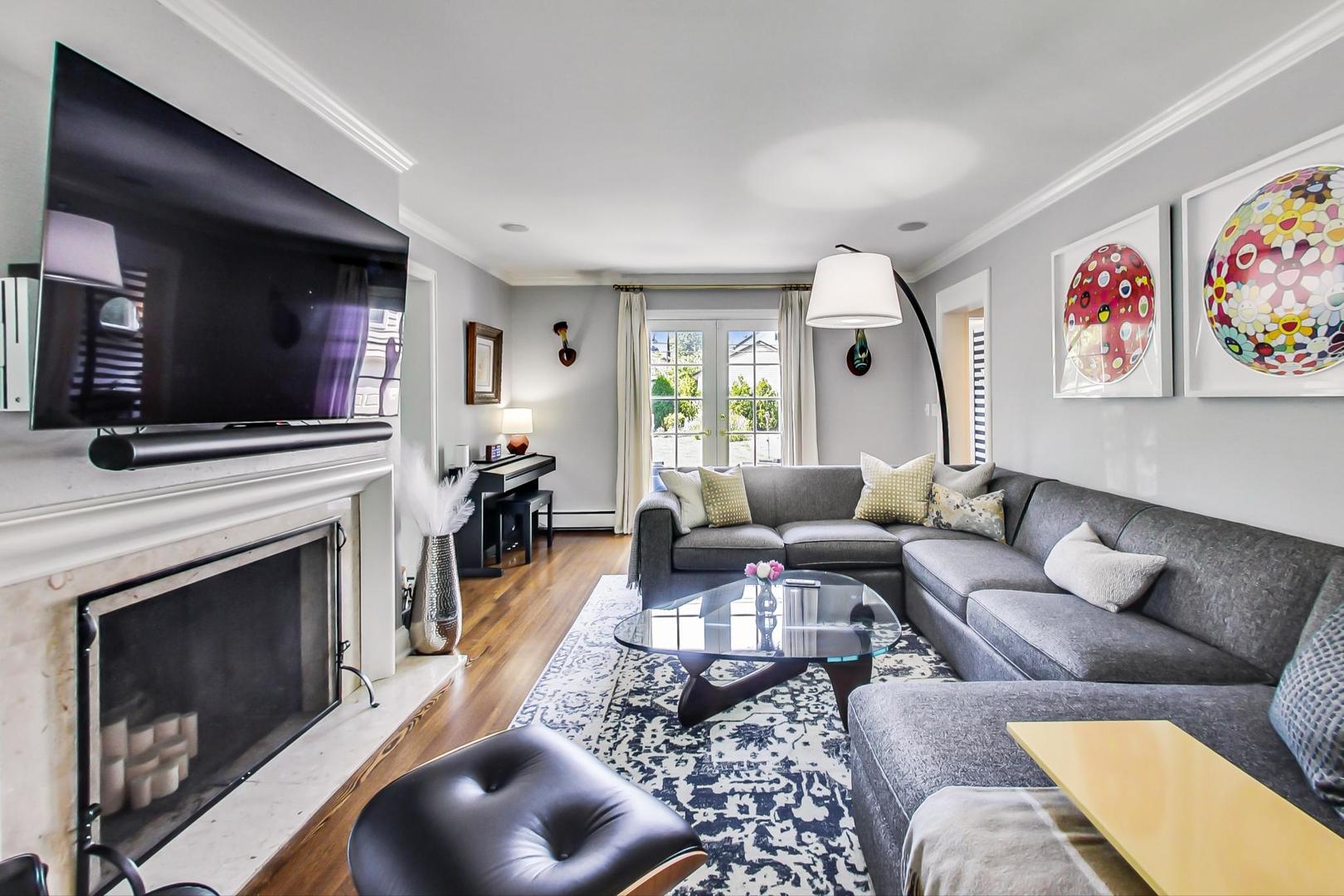 385 Washington Avenue Glencoe, IL 60022 - Photo 7 of 50 a living room with furniture a flat screen tv and a fireplace