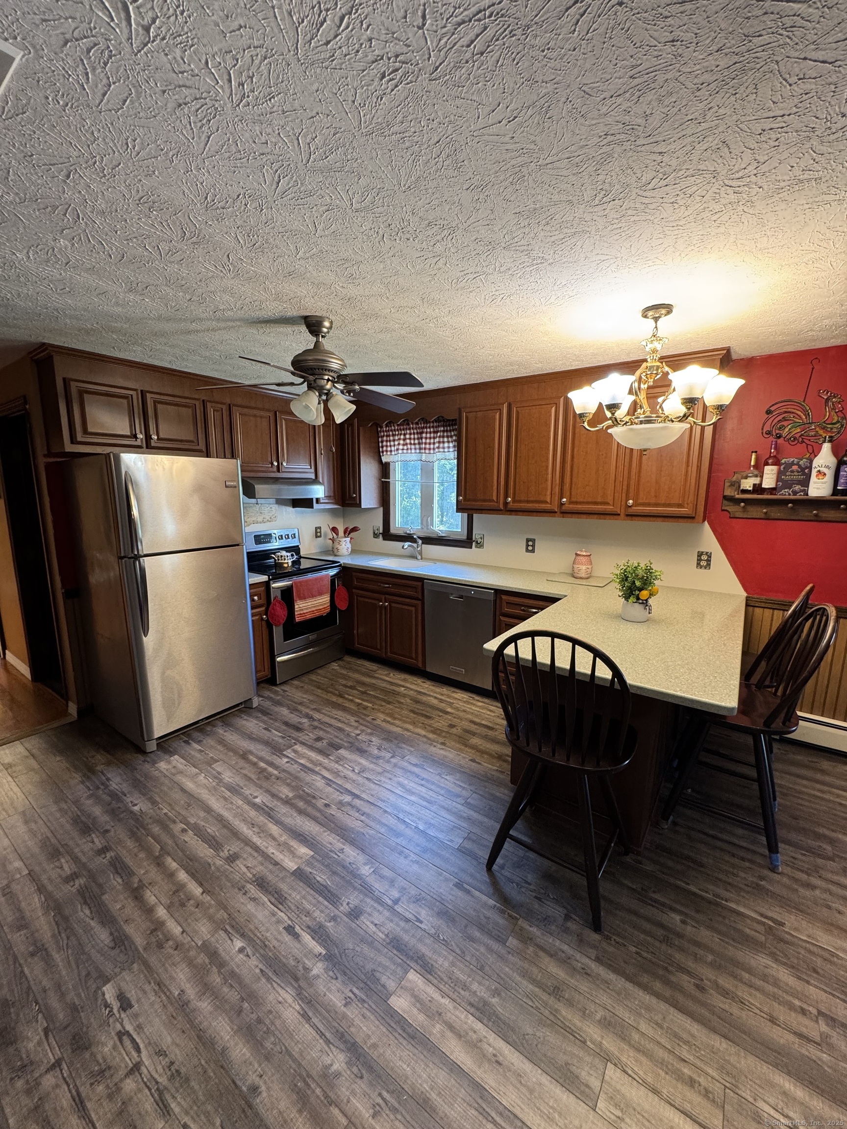 67 Royal Oak Circle Meriden, CT 06450 - Photo 13 of 25 a living room with kitchen island furniture wooden floor and a kitchen view