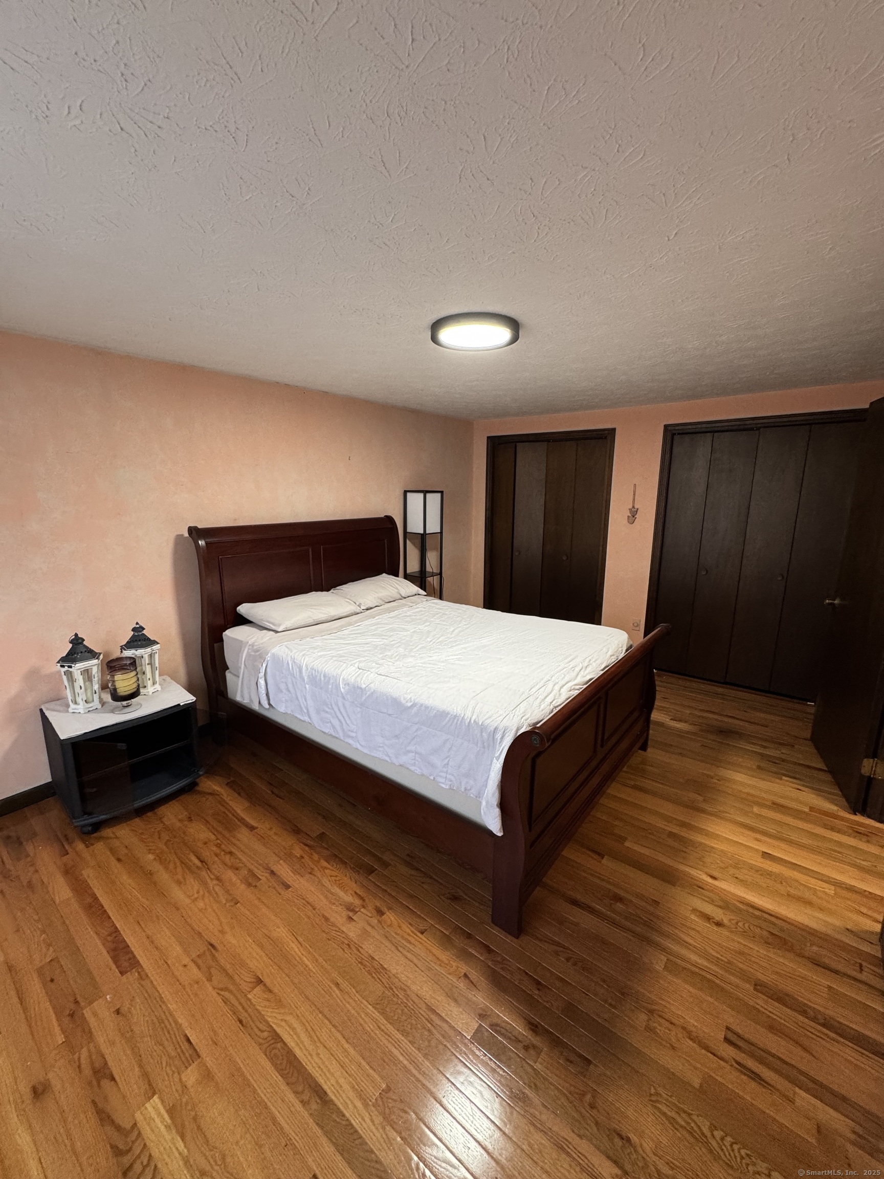 67 Royal Oak Circle Meriden, CT 06450 - Photo 17 of 25 a bedroom with a bed and wooden floor