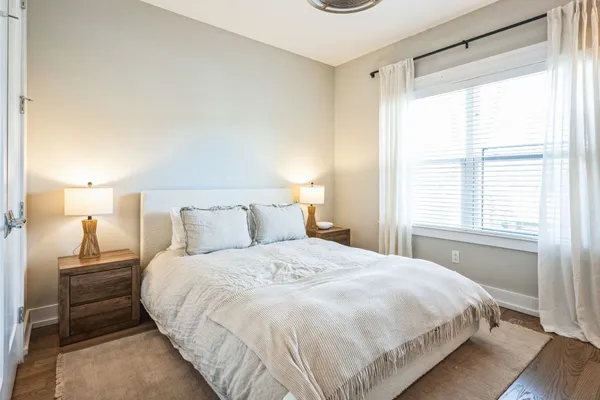 a bedroom with a bed and a window