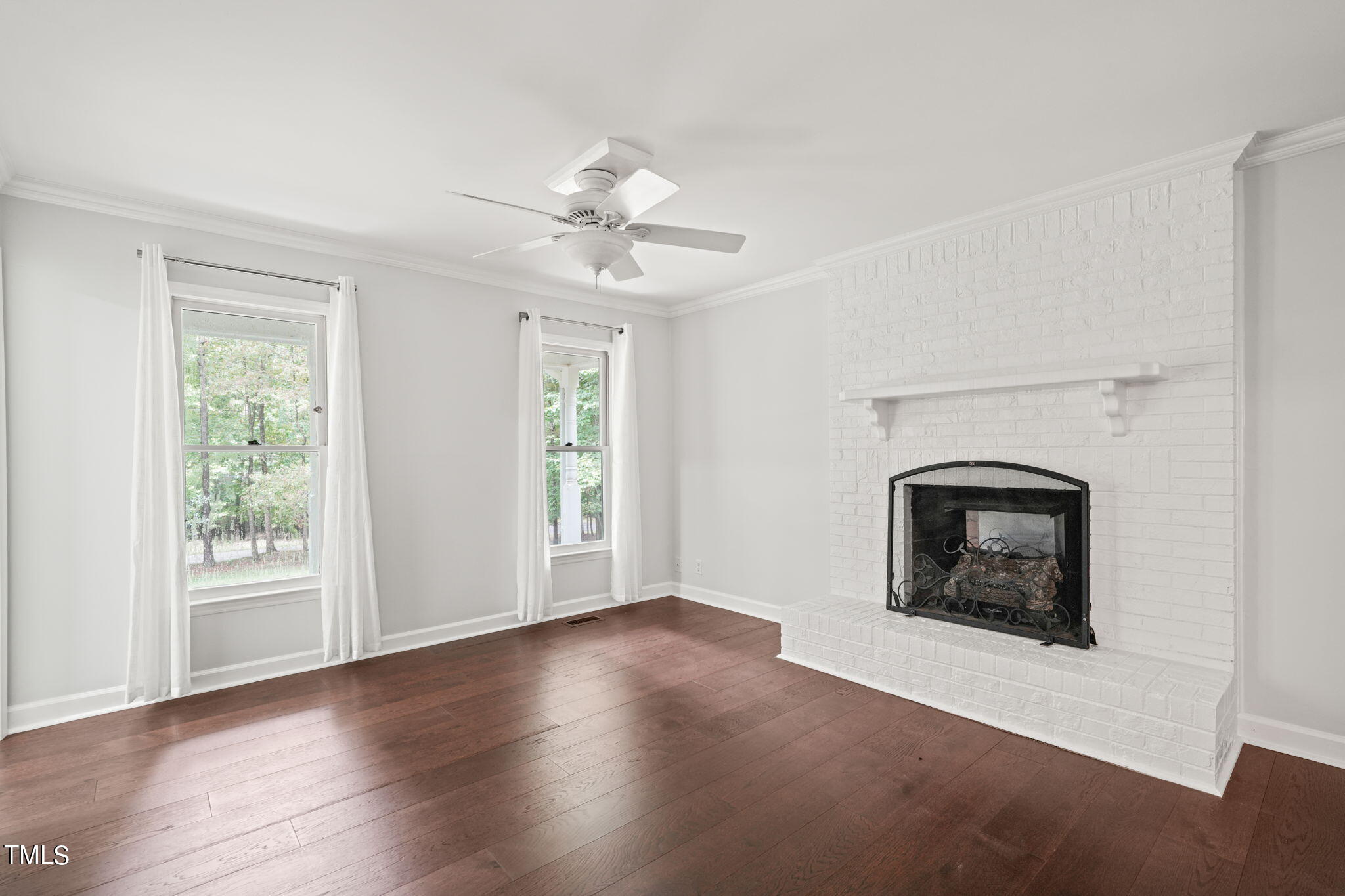 2835 Fox Drive Durham, NC 27712 - Photo 11 of 53 a view of an empty room with a fireplace and a window