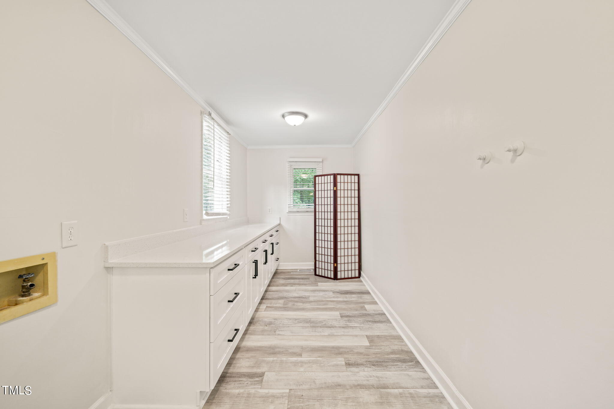 2835 Fox Drive Durham, NC 27712 - Photo 21 of 53 a hallway with white cabinets and white appliances