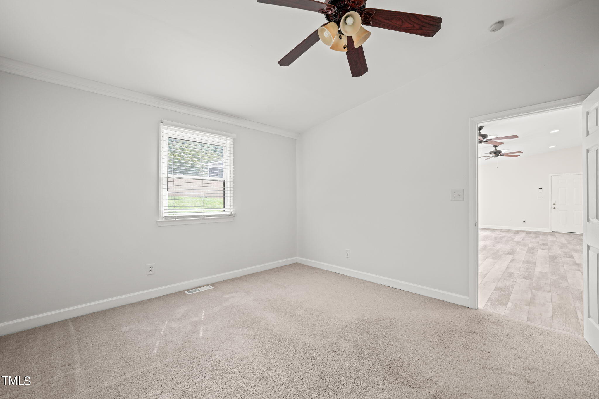 2835 Fox Drive Durham, NC 27712 - Photo 25 of 53 an empty room with a window and a fan