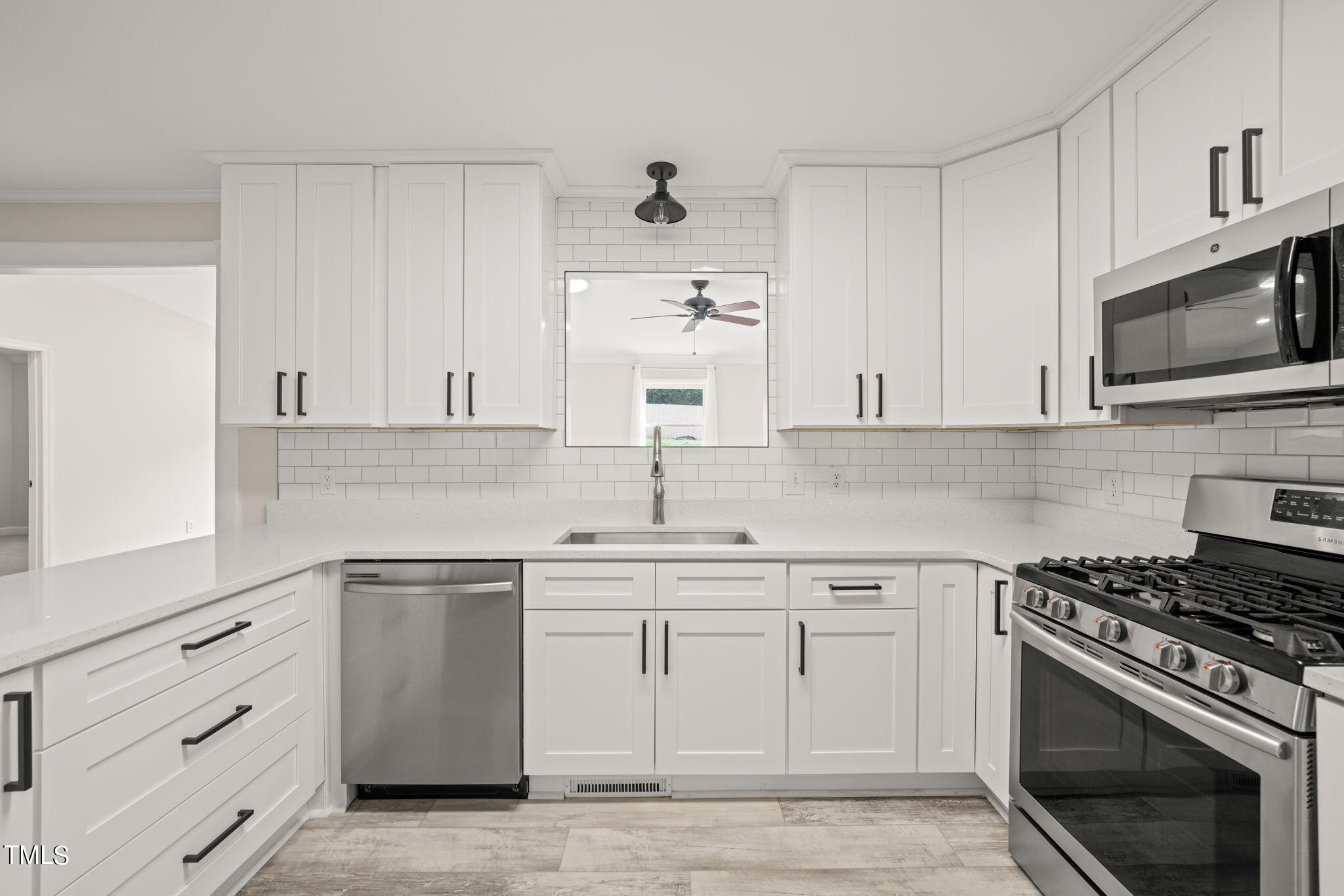 2835 Fox Drive Durham, NC 27712 - Photo 5 of 53 a kitchen with white cabinets stainless steel appliances and sink