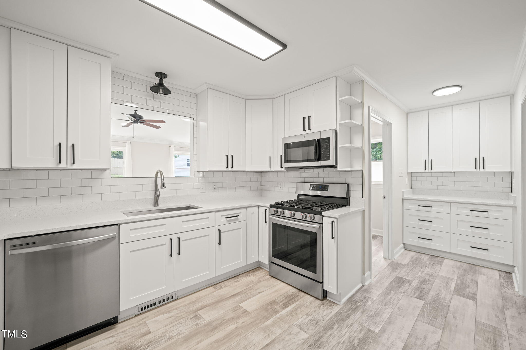 2835 Fox Drive Durham, NC 27712 - Photo 6 of 53 a kitchen with cabinets stainless steel appliances a sink and wooden floor
