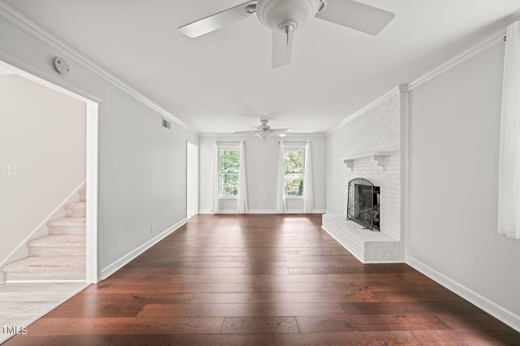 2835 Fox Drive Durham, NC 27712 - Photo 10 of 53 a view of an empty room with wooden floor and a window