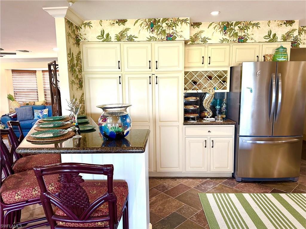 410 Cristobal Street Naples, FL 34113 - Photo 15 of 50 a kitchen with stainless steel appliances granite countertop a refrigerator and a stove