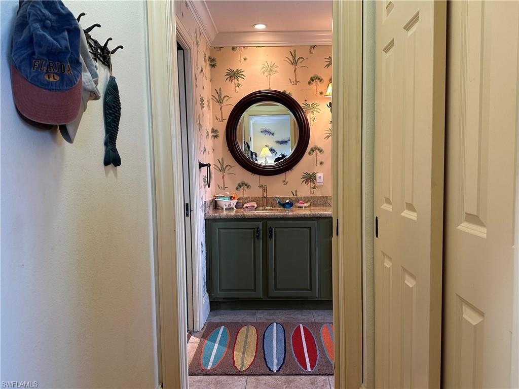 410 Cristobal Street Naples, FL 34113 - Photo 20 of 50 a bathroom with a sink and a mirror