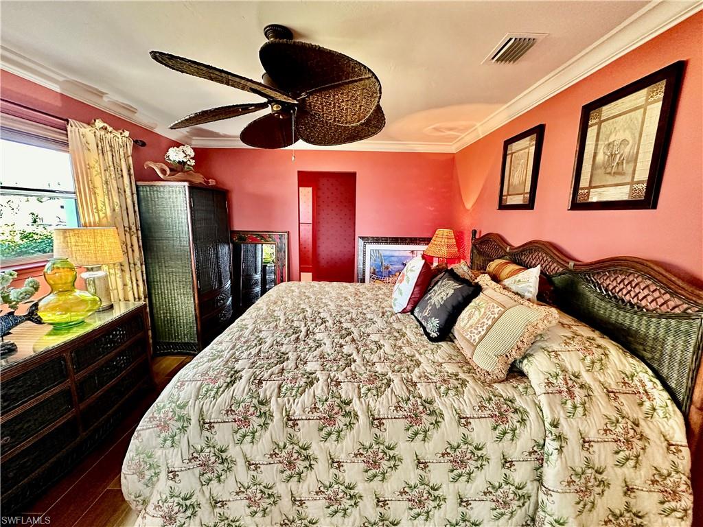 410 Cristobal Street Naples, FL 34113 - Photo 25 of 50 a bedroom with a bed and dresser with large mirror