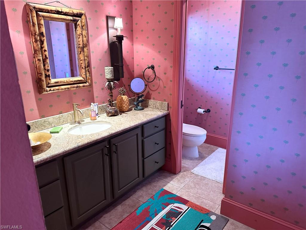 410 Cristobal Street Naples, FL 34113 - Photo 26 of 50 a bathroom with a sink and a mirror