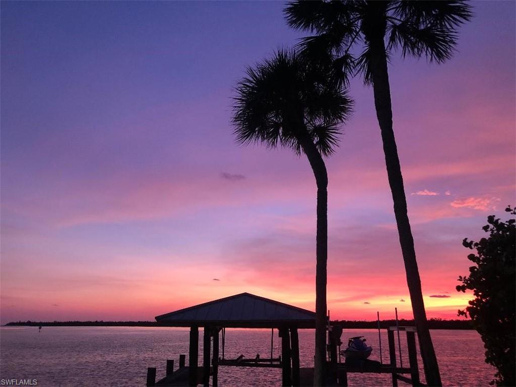 410 Cristobal Street Naples, FL 34113 - Photo 35 of 50 a front view of a house with a garden