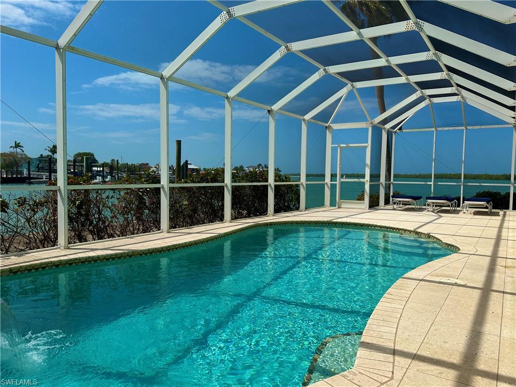 410 Cristobal Street Naples, FL 34113 - Photo 4 of 50 a swimming pool with lawn chairs and pool view