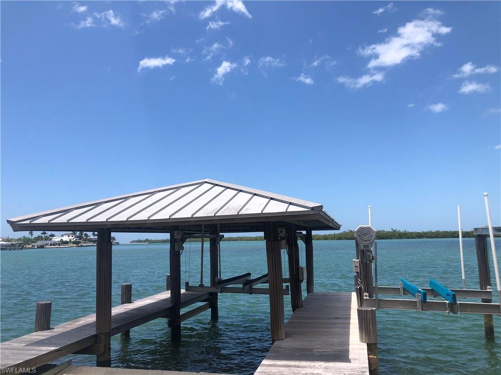 410 Cristobal Street Naples, FL 34113 - Photo 43 of 50 a roof deck with table and chairs