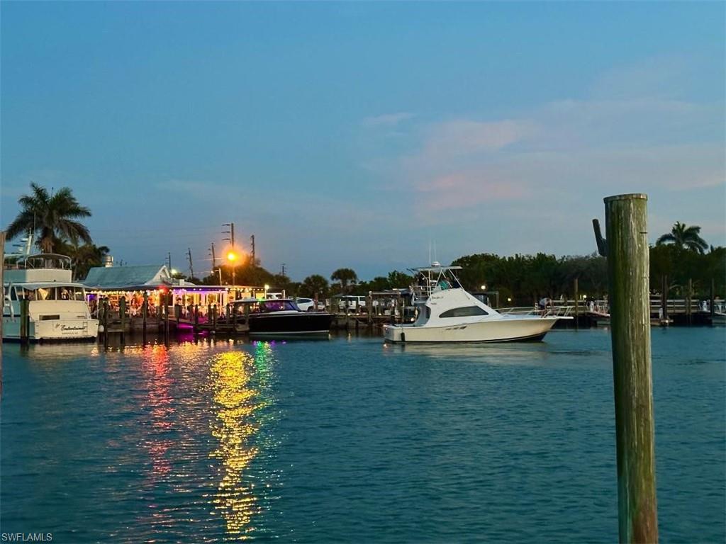 410 Cristobal Street Naples, FL 34113 - Photo 49 of 50 a view of a lake with boats and trees in the background