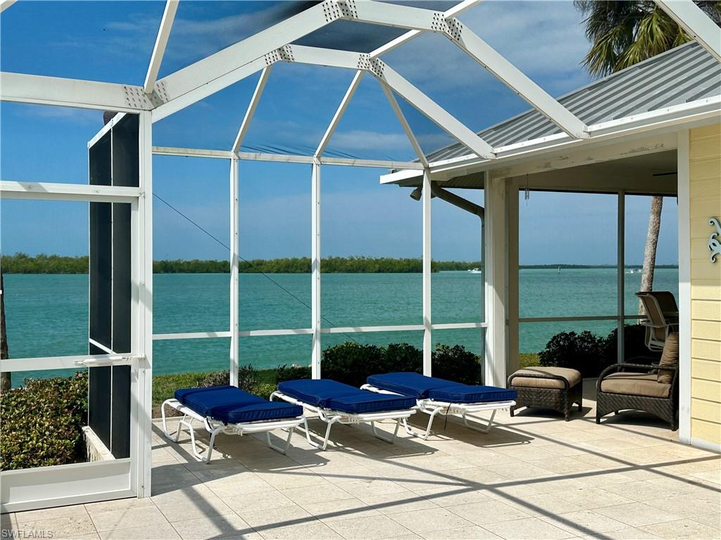 410 Cristobal Street Naples, FL 34113 - Photo 5 of 50 a view of a patio with a table and chairs and potted plants