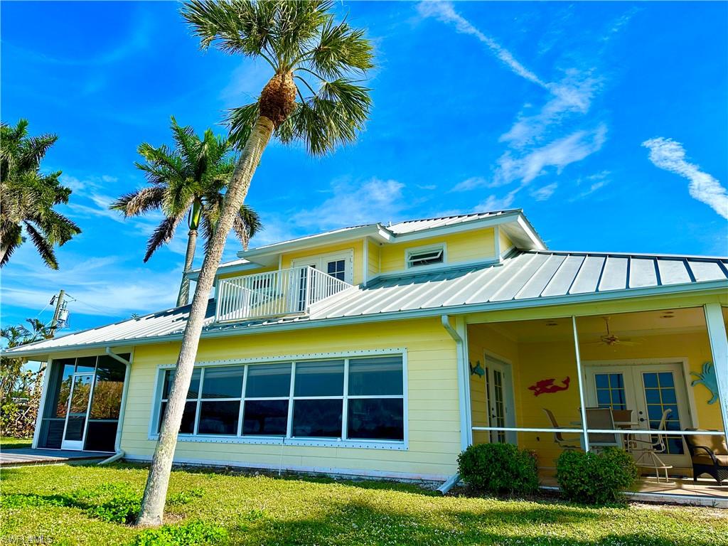 410 Cristobal Street Naples, FL 34113 - Photo 6 of 50 a view of a house with a yard