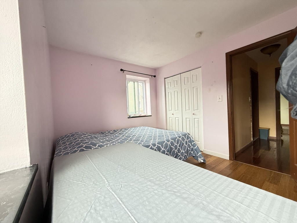 215 Washington Avenue, Unit 9 Chelsea, MA 02150 - Photo 10 of 17 a bedroom with a bed and a dresser